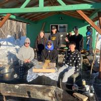 Nenana Culture Class students share homemade moose soup with mushers, visitors